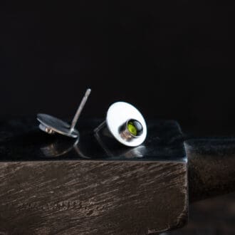 silver stud earrings featuring silver discs with green tourmaline gemstones