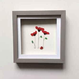 three red poppies made with Cornish sea glass set in a 24cm glazed frame