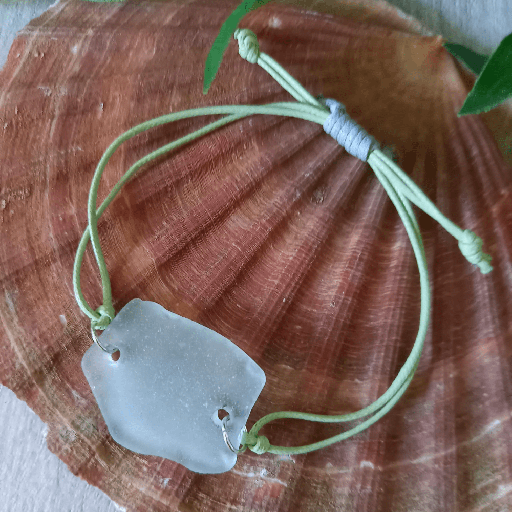 seaglass bracelelt sitting on shell