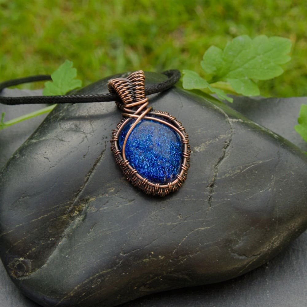 Small copper wire weave pendant with dark blue dichroic glass