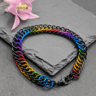 Half persian chainmaille bracelet made with black and rainbow coloured rings