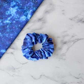 Blue cosmic scrunchies. pattern on fabric looks like stars in the universe