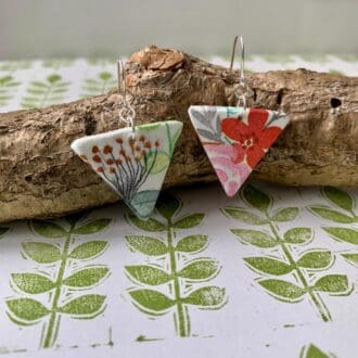 Triangle shaped boho floral drop earrings. The pattern is mismatched to create a quirky vibe.