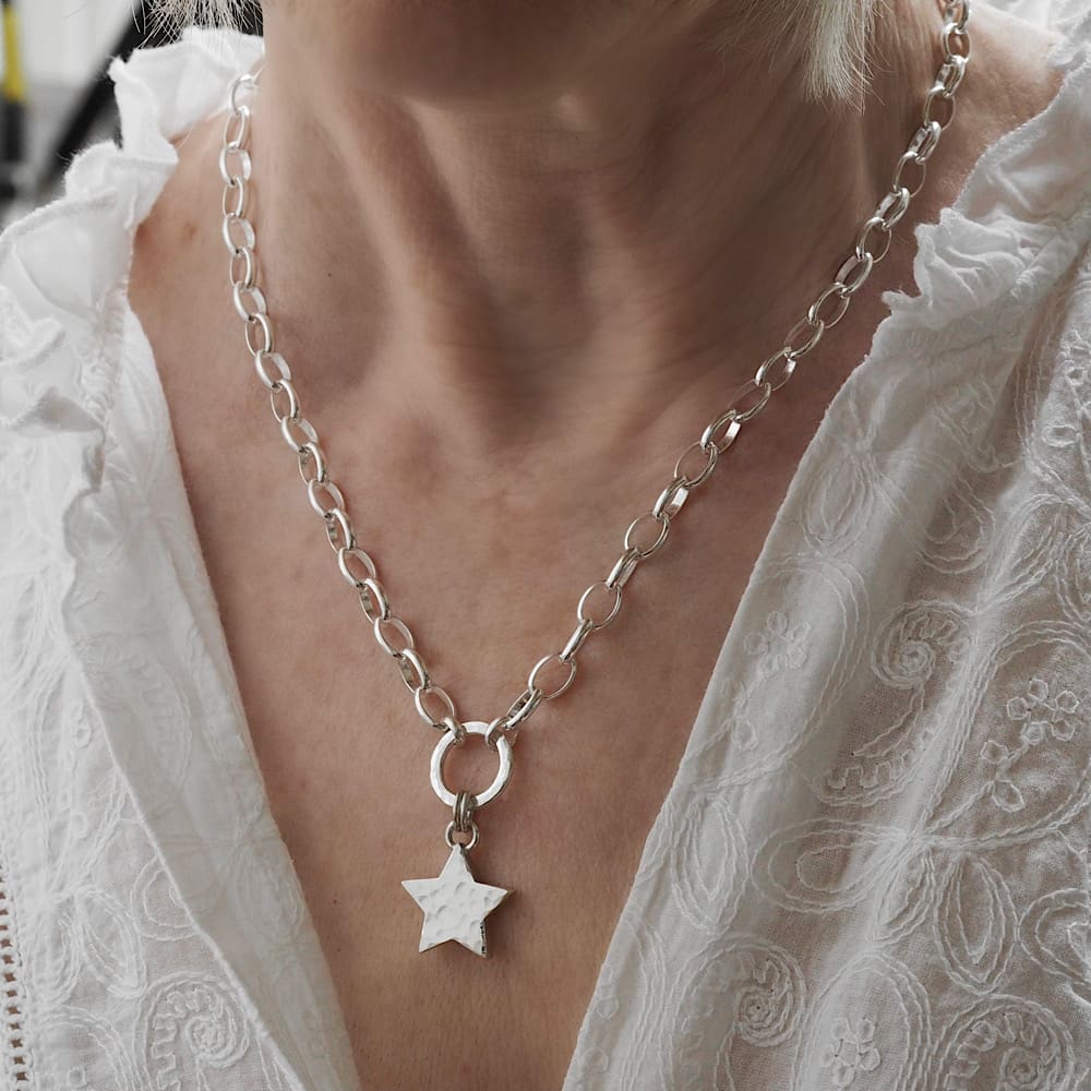Chunky sterling silver hammered star pendant on large linked 18in belcher chain shown on model