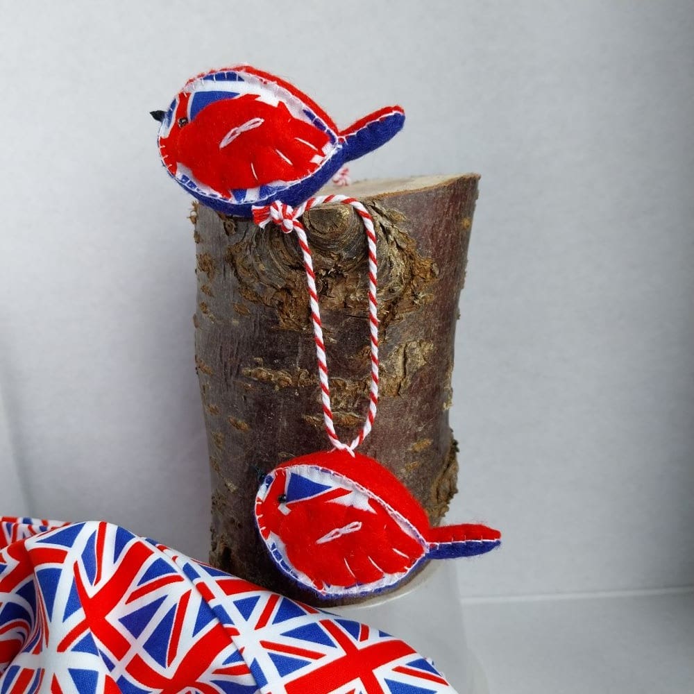 A hand sewn felt and fabric bird. Made from red and blue felt with fabric sides. The fabric is a union flag pattern