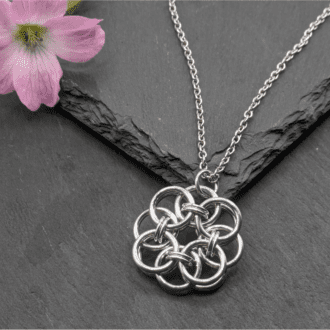 Helm chainmaille pendant made from bright aluminium rings on a stainless steel chain