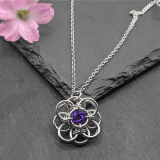 Helm flower chainmaille pendant made from bright aluminium and purple anodizes aluminium rings on a stainless steel chain