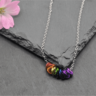 Multi mobius chainmaille necklace made from seven different coloured mobius units made in the colours of the rainbow on a stainless steel chain