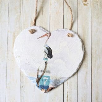 Slate hanging heart painted white and decoupaged with a simple coastal pelican design. Finished with a twine hanger