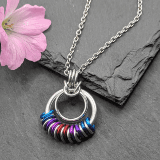 Chainmaille pendant made with bright coloured aluminium and silvered coloured aluminium rings on a stainless steel chain