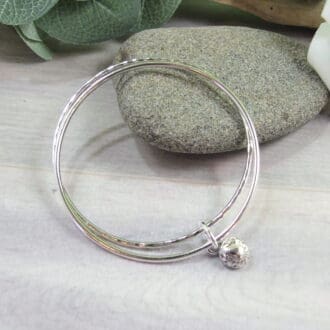 silver bangle set with fower charm