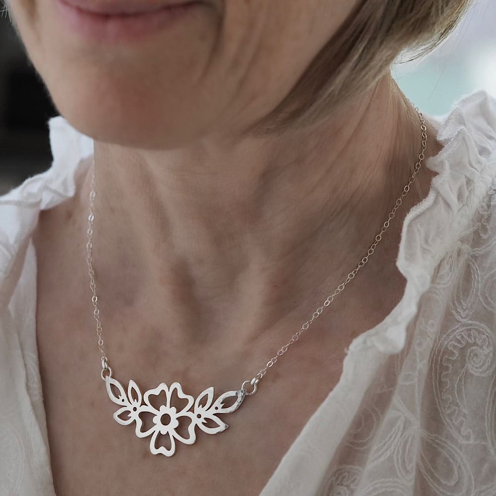 Hammered Cutwork Sterling silver flower and leaf motif pendant on a delicate flat trace chain modelled