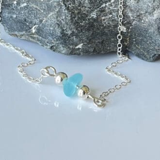 Frosted Sea Glass, paired with a couple of Sterling Silver Beads.