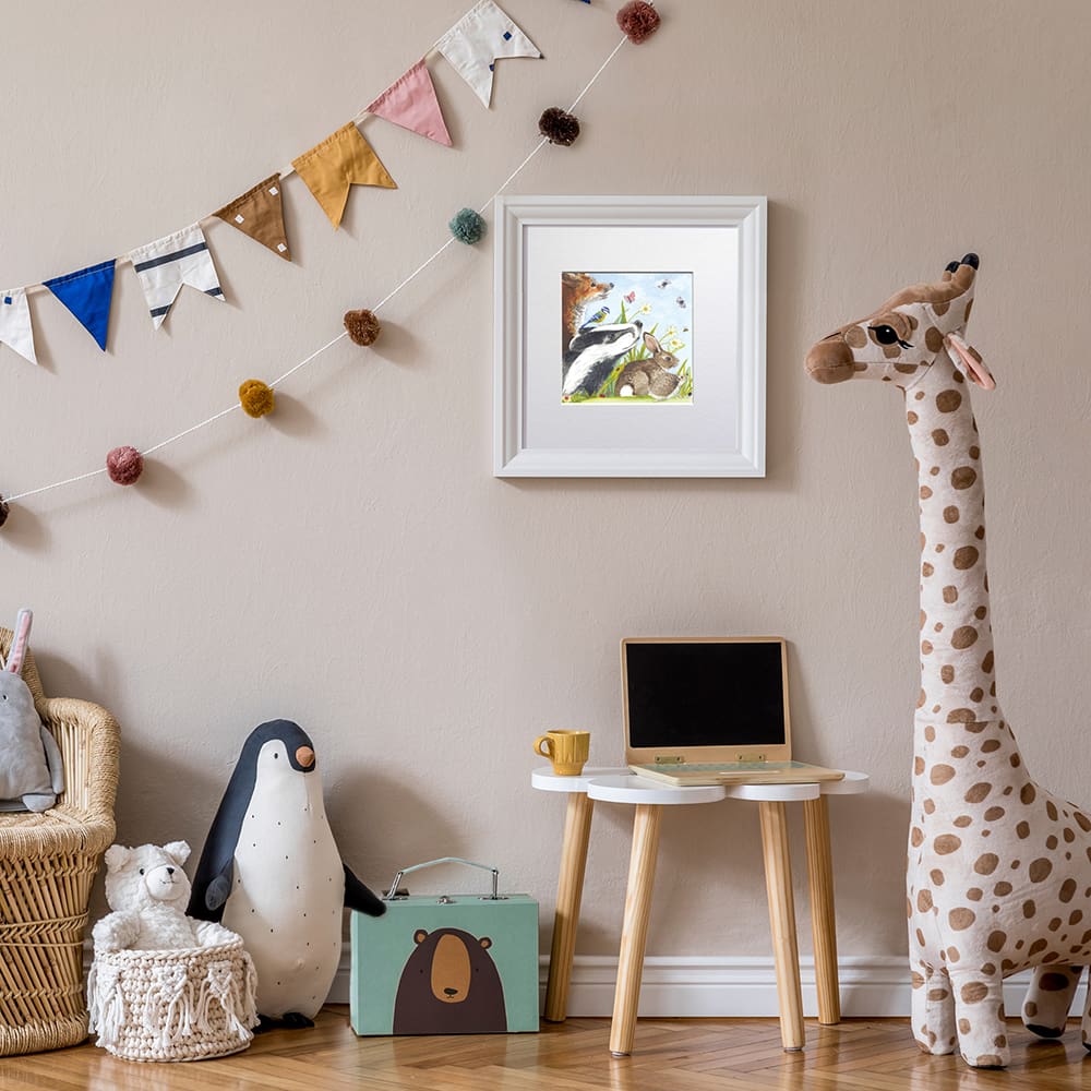 Wildlife picture of a selection of British animals situated on a kids playroom wall. Giclee print with a white mount. Shown in a readily available standard size square white frame