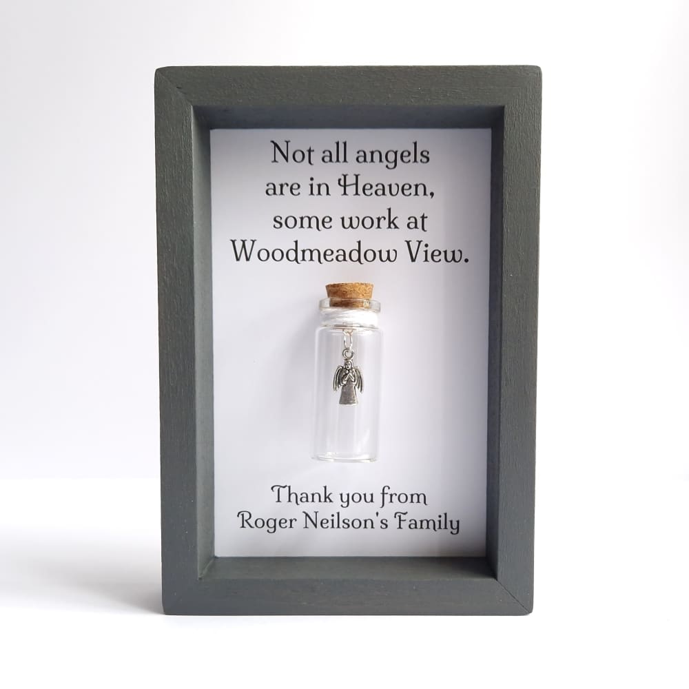 Grey frame with a glass bottle insert containing an angel charm, thank you gift for care home