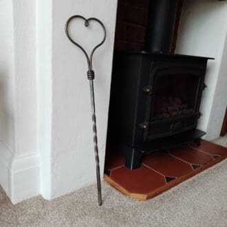 fire poker with a heart shaped top, hand forged by Chris The Smith