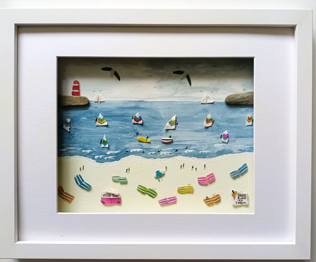 large framed picture of a busy cornish beach featuring colourful wind breaks and windsurfers made from beachcombed finds