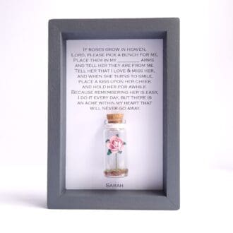 Small grey frame with personalised if roses grow in heaven quote with a miniature glass bottle insert containing a paper rose
