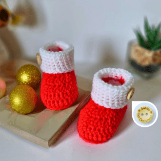 Baby's 1st christmas cute baby booties, made with a red foot and a white cuff, then finished with a 'baby's 1st Christmas' wooden button