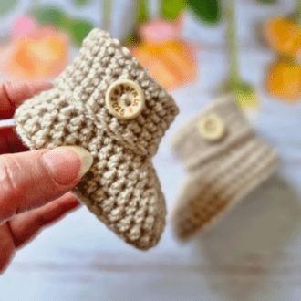 baby booties, crochet with 'born in 2025' wooden buttons attached to the cuff, they make a great new baby gift or newborn keepsake