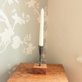 Cone shaped candle holder set into a piece of oak. 16 cm tall.