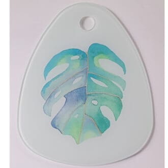 Glass serving board featuring Monstera Leaf artwork