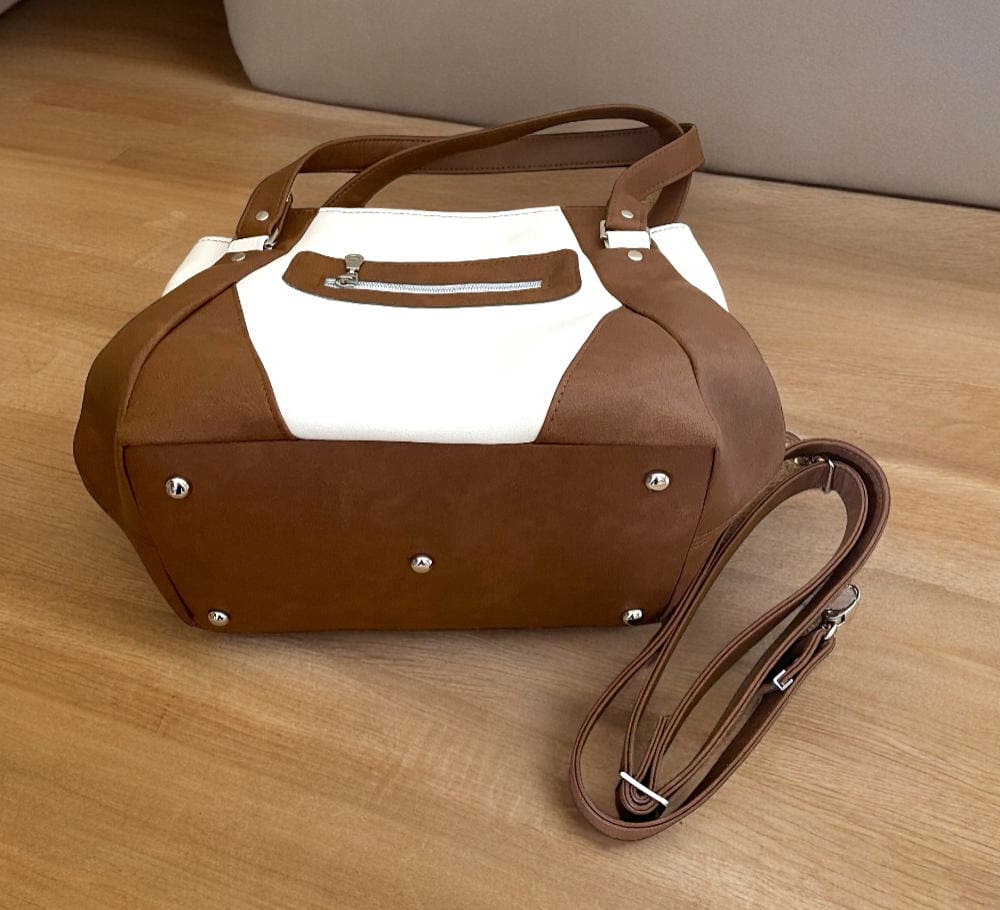 Tan and cream handbag showing rear and back