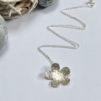 Large silver flower necklace. Patterned and domed handmade from recycled silver