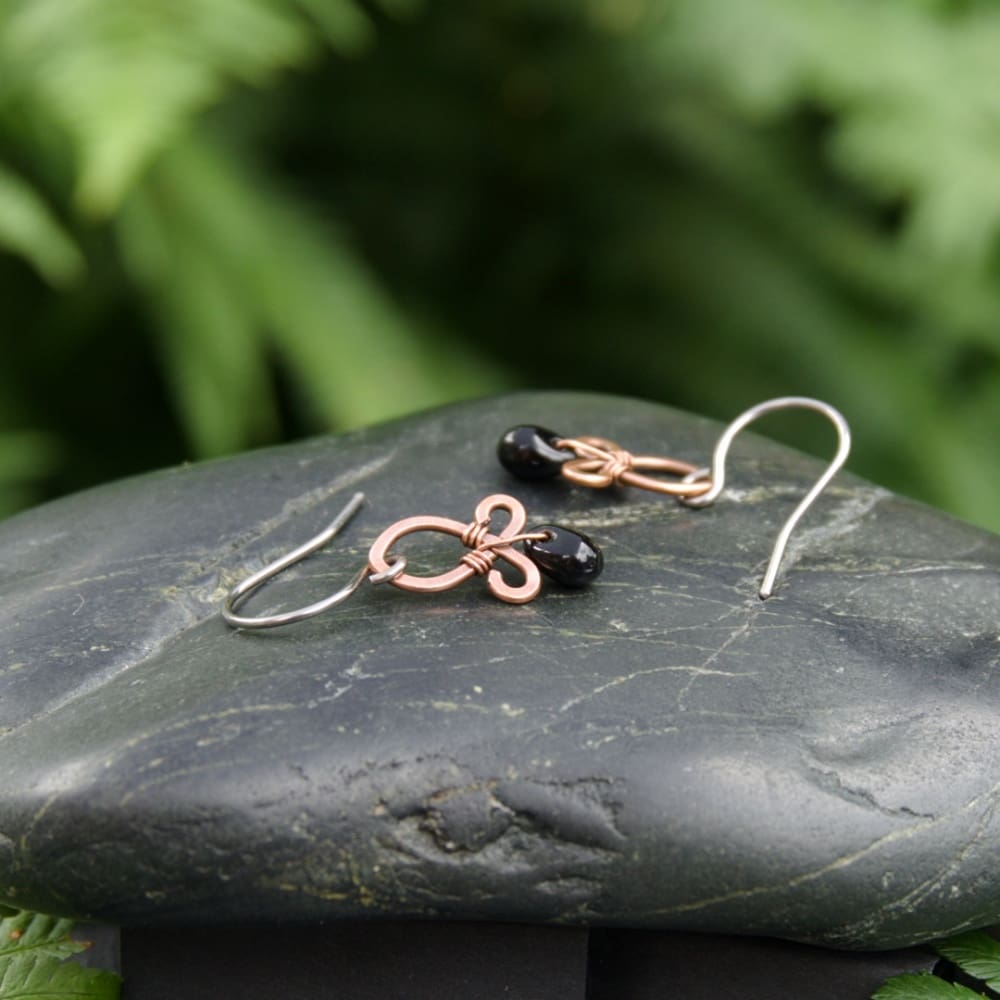 handmade copper dangle earrings with black glass beads by oruki design