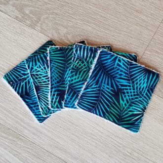 A set of five reusable face wipes with fern leaves on the cotton top fabric.