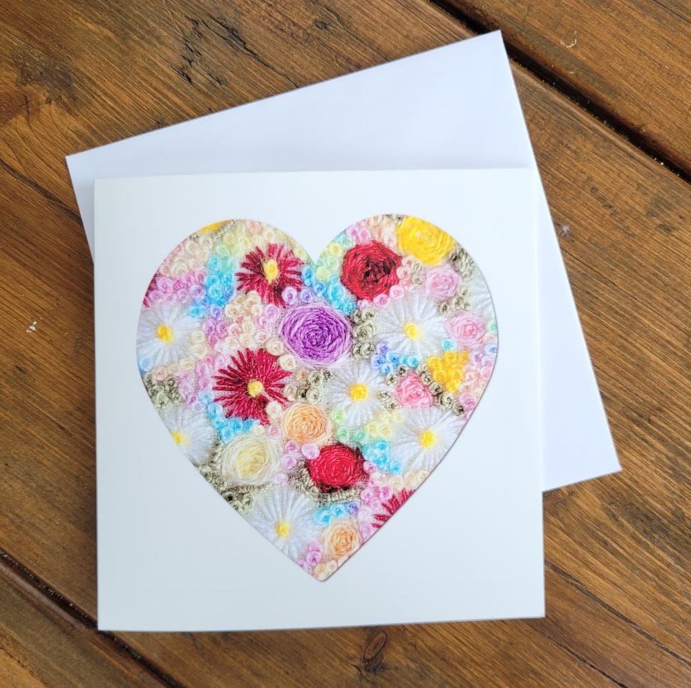 Printed greetings card from original embroidered artwork of a heart filled with embroidered flowers.