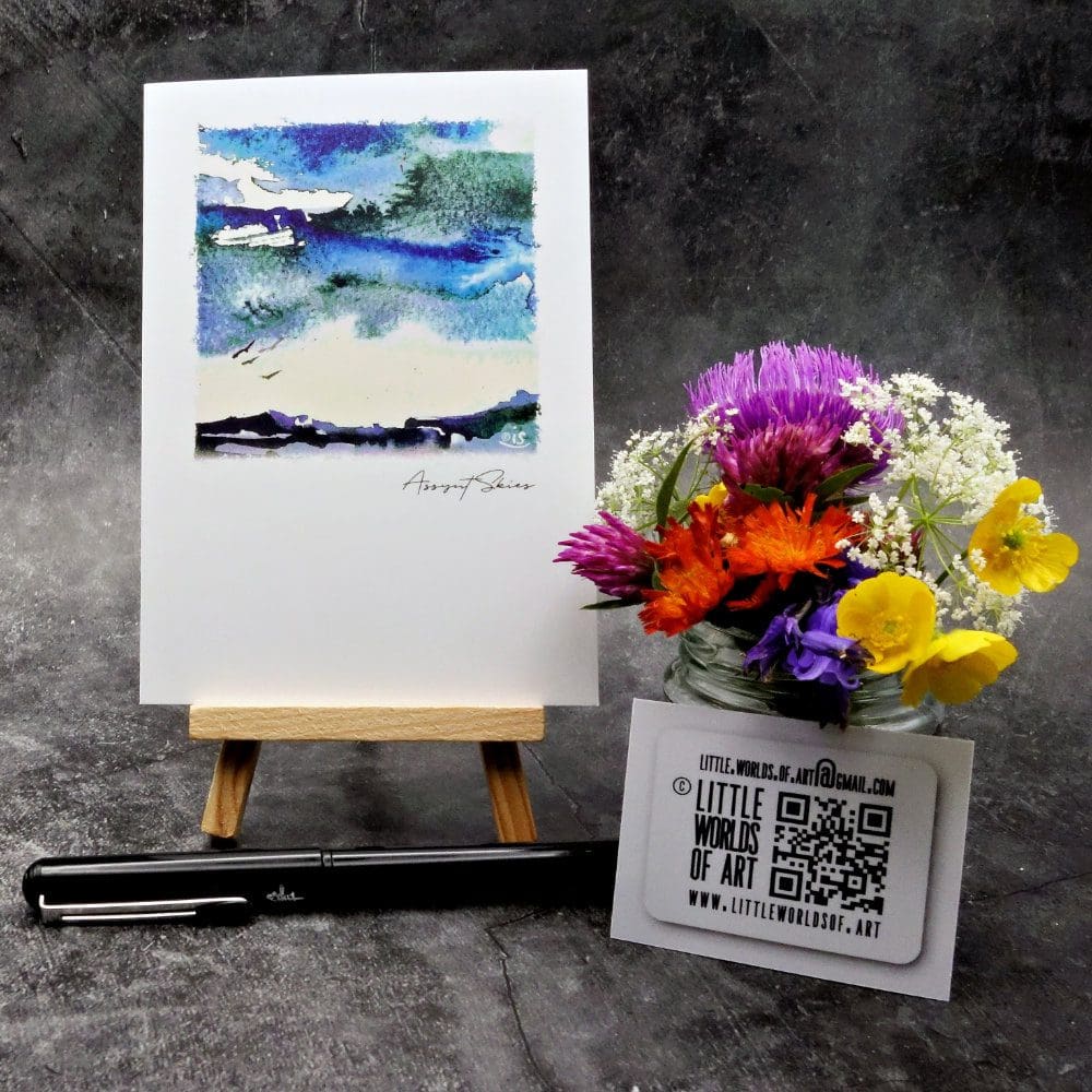 Image showing an A6 size greetings card, blank inside, on a small easel displaying an Assynt skyscape.