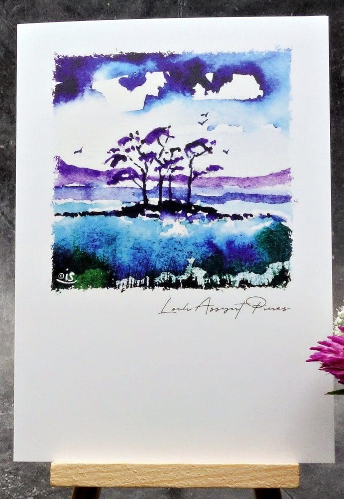 Larger image showing an A6 size greetings card, blank inside, on a small easel displaying a view of some of the famous Loch Assynt Pines