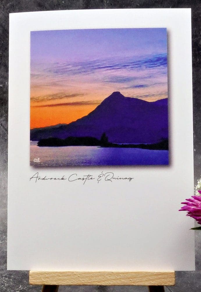 Larger image showing an A6 size greetings card, blank inside, on a small easel displaying a summer's evening view of Quinag and Loch Assynt