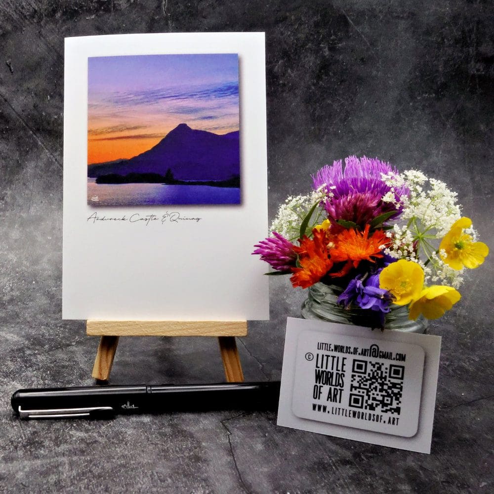 Image showing an A6 size greetings card, blank inside, on a small easel displaying a summer's evening view of Quinag and Loch Assynt