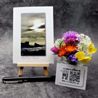 Image showing an A6 size greetings card, blank inside, on a small easel displaying a view of Split Rock at Clachtoll in Assynt!