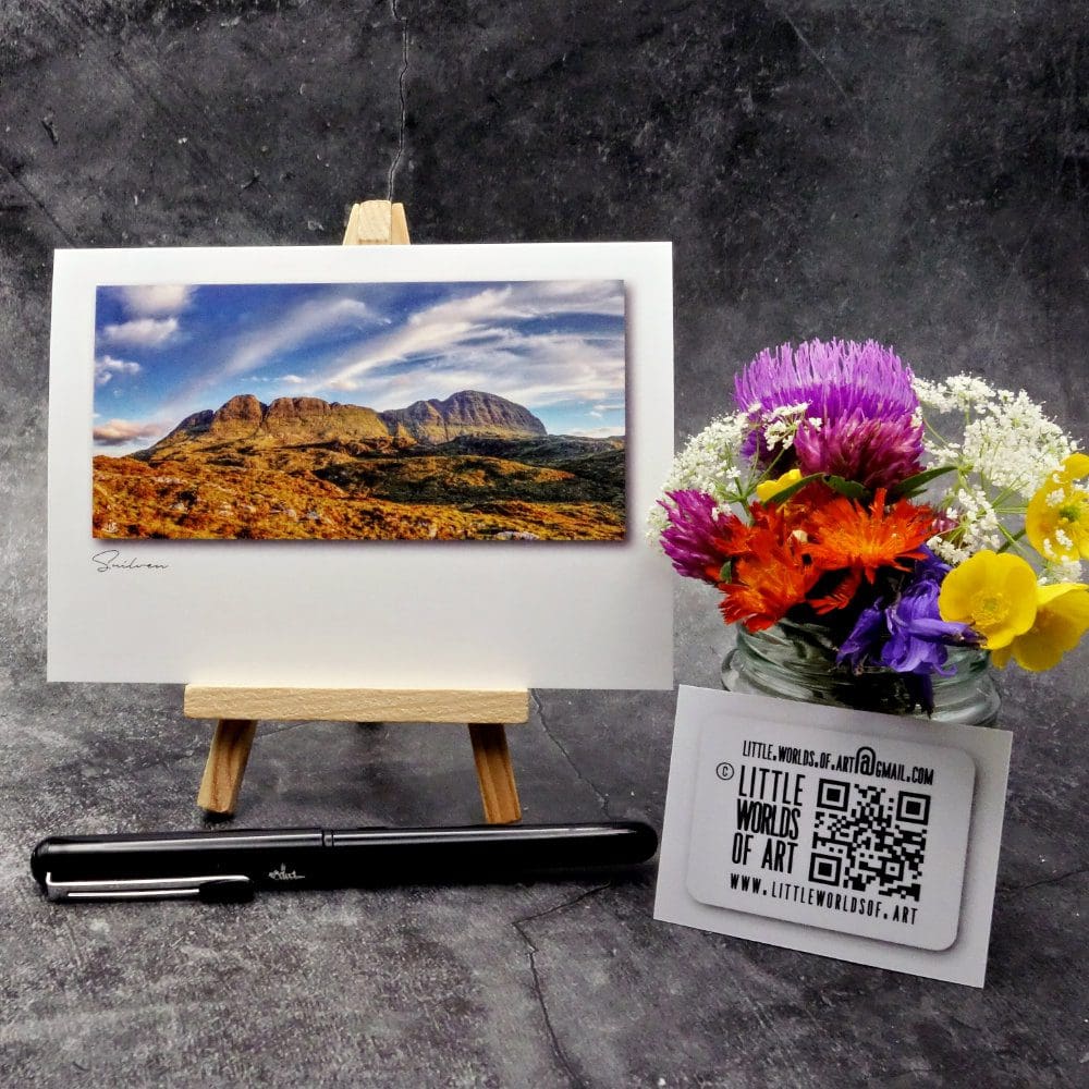 Image showing an A6 size greetings card, blank inside, on a small easel displaying an evening view of Suilven's north face.