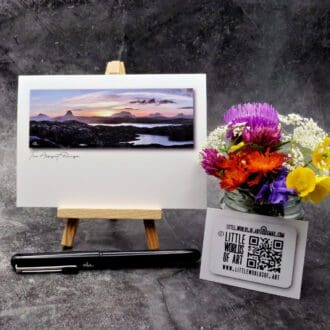 Image showing an A6 size greetings card, blank inside, on a small easel displaying a morning sunrise over the Assynt mountain range.