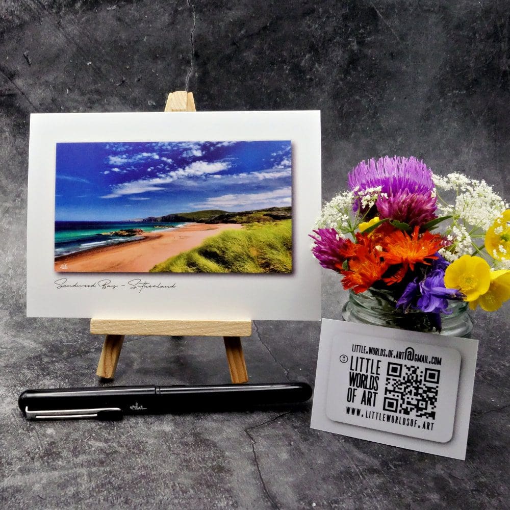 Image showing an A6 size greetings card, blank inside, on a small easel displaying a colourful picture of Sandwood Bay in Sutherland looking North.