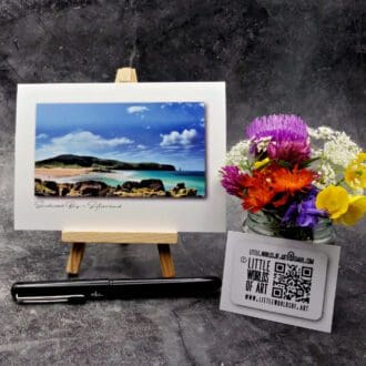 Image showing an A6 size greetings card, blank inside, on a small easel displaying a colourful picture of Sandwood Bay in Sutherland looking South.