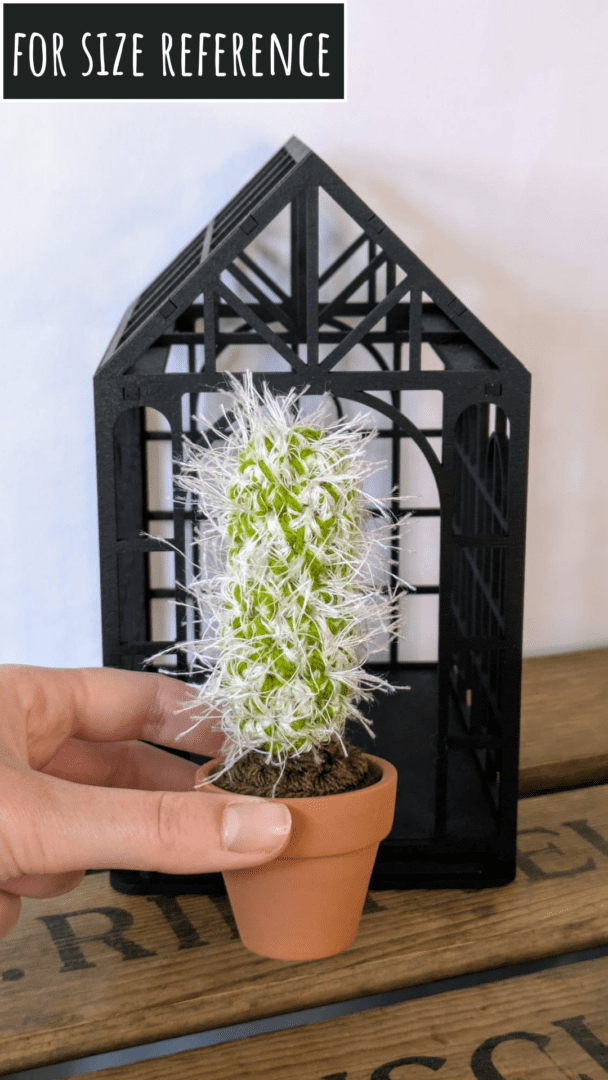 Spiky Crochet Cactus in a Mini Terracotta Pot Held in a Hand to Show for Size Reference