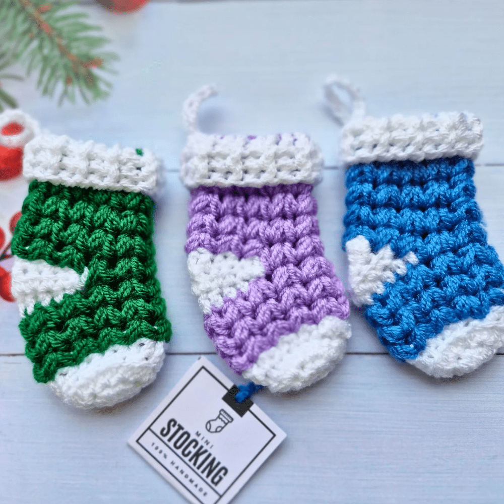 3 mini Christmas stockings in green, wisteria and cornish blue with white heels and toes