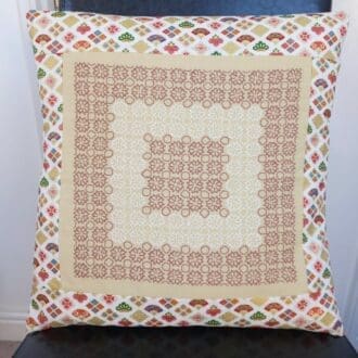 CReam and brown embroidered cushion