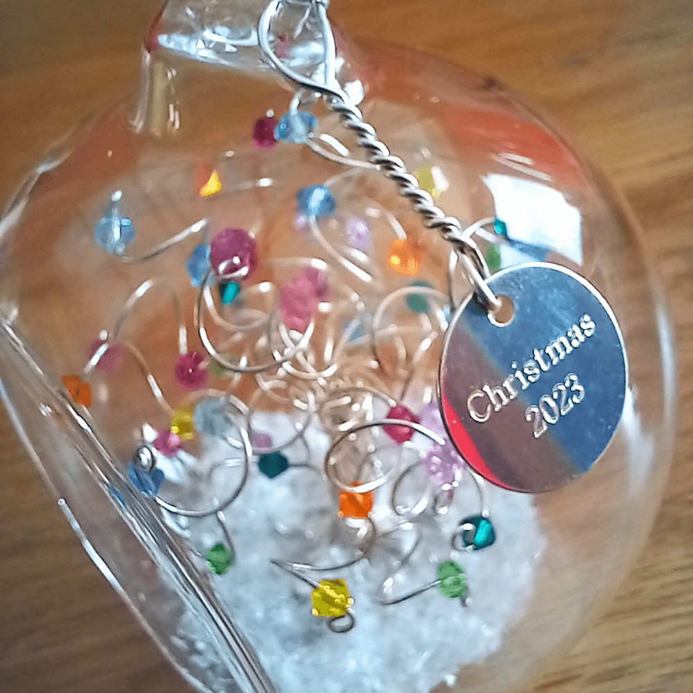 8cm glass bauble with an engraved silver disc charm wired onto the outside of the bauble to add personalisation. This one has the wording Christmas 2023.