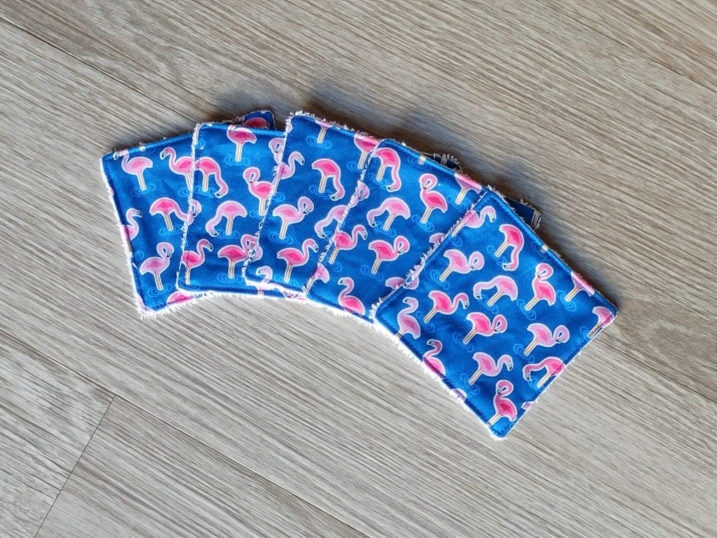 Set of 5 reusable face wipes with a flamingo print cotton fabric and bamboo towelling.