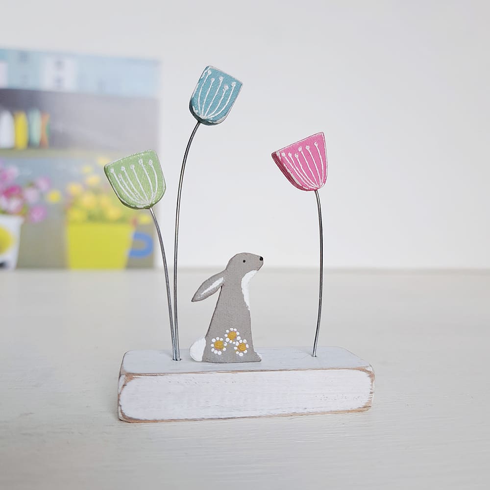 Tiny handmade ornament with colourful wooden flowers and a tiny hare decorated with daisies