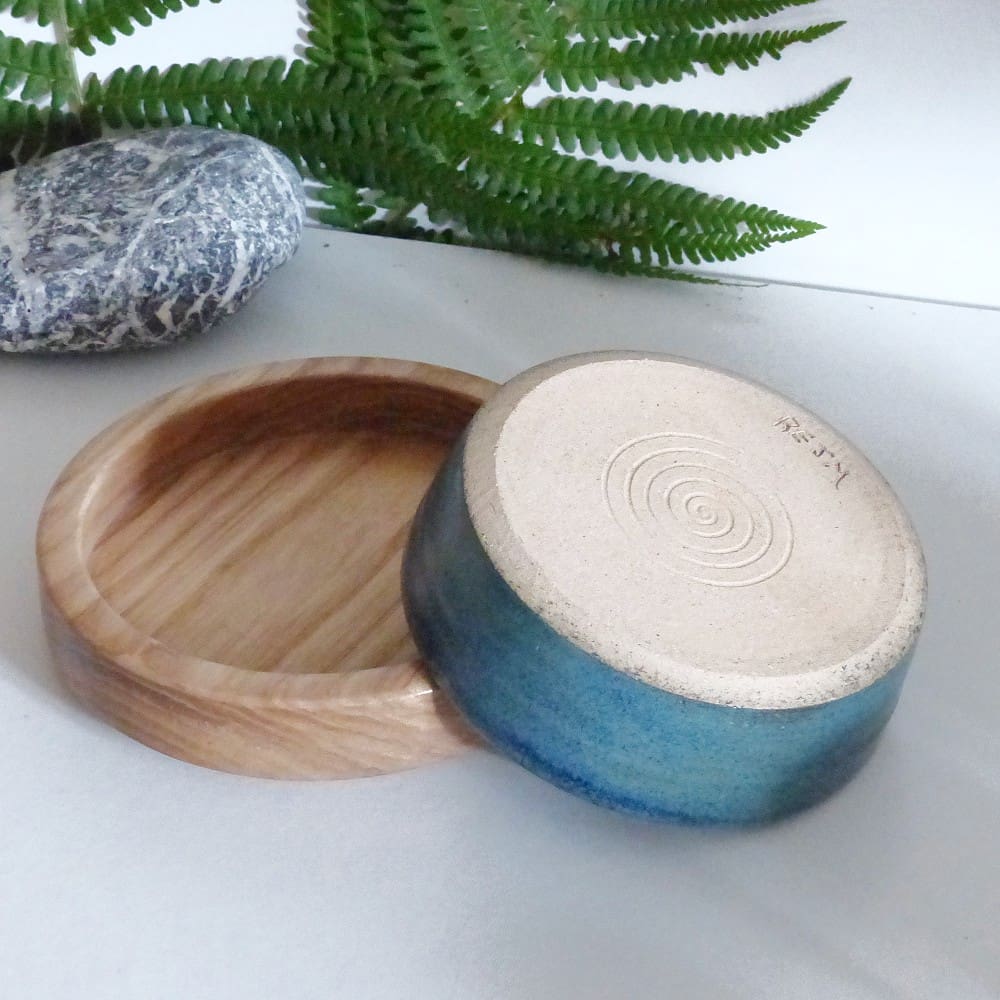 Stoneware ceramic handmade dish and wooden trivet.