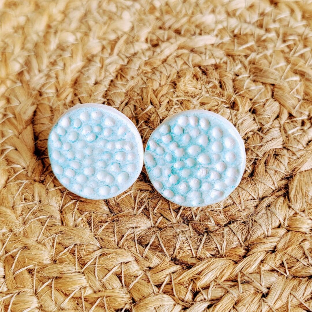 Handmade clay stud earrings textured with a simple dot pattern