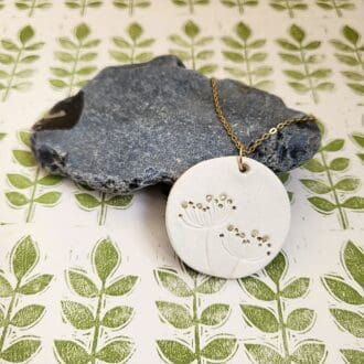 Round pendant necklace with a botanical print