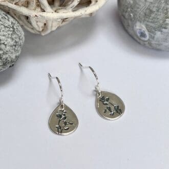 Silver teardrop dangle earrings with oxidised leaf pattern